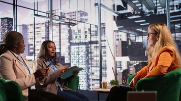 Diverse group of ambitious businesswomen engaged in a strategic meeting, focused on career progression within a multinational company. Women CEO shares ideas with investors. Camera B. video
