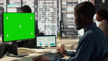 Male administrator focused on financial planning next to chroma key screen, reviewing infographics for data analysis and company strategy. Businessman ensuring enterprise solutions. Camera A. video