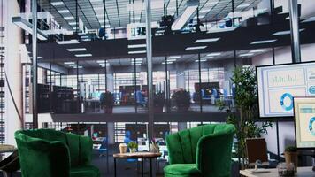 Luxurious office space in a multinational company with a monitor, presenting performance metrics and data analysis on a TV screen. Modern workspace in a corporation used for meetings. video