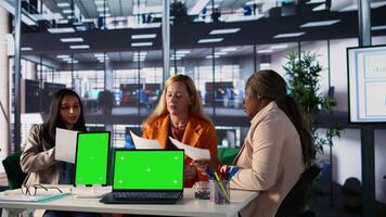 Team of female shareholders meeting to discuss expansion plan next to isolated mockup, sharing their ideas to use more funds on a development project. Working for success and productivity. Camera B. video