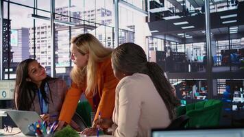Diverse general managers collaborate in office analyzing data for expansion plan, corporate feminism. Female CEOs discussing strategies for leadership development, achieve greatness. Camera B. video