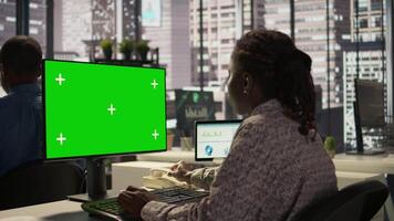 African American specialist looks at isolated mockup on computer, analyzing company data for strategic planning and enterprise goals. Resource allocation and effective business operations. Camera B. video