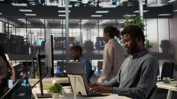 Professional black director leading a conference with his staff, discussing project details and strategic objectives. Virtual chat ensures efficient communication across locations. Camera B. video
