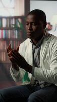 Vertical Psychologist in a serious consultation with a doctor physician in cabinet, listening to career difficulties and mental health struggles. Depressed medic discussing about PTSD in therapy. Camera B. video