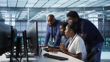Teamworking engineers talking in server room, developing disaster recovery plans ensuring minimal downtime. Team of data center employees doing brainstorming, monitoring performance, camera A video