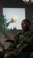 Vertical Black army soldier in wheelchair is a war survivor and deals with shell shock, experiencing a bad case of PTSD and anxiety. Wounded trooper opening up about horror combat scenes. Camera A. video