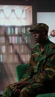 Vertical Anxious depressed private sharing his struggles with combat flashbacks, counseling session with psychiatrist for rehabilitation. Psychological support and reintegration for soldiers. Camera A. video