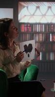 Vertical Psychoanalyst shows a paper with Rorschach test illustration to male nurse during counseling session, testing imagination to get answers for mental health issues, dealing with anxiety. Camera A. video
