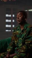 Vertical Distraught soldier in tears sharing his struggles with war PTSD, attends therapy session with expert for rehabilitation. Psychological support and society reintegration for veterans. Camera B. video