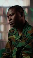 Vertical African american soldier remembering war flashbacks and dealing with a serious case of shell shock syndrome, traumatic memories. Armed forces veteran feels guilty with PTSD. Camera B. video