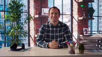 Manager in home office sitting at desk, filming onboarding for job candidates. Supervisor doing human relations job, recording answering inquiries from employees, camera A video