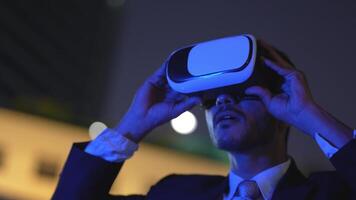 Businessman in a formal suit experiencing virtual reality with a VR headset. Modern technology meets professional innovation, exploring immersive solutions for business and communication. video