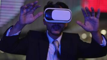 Businessman in a formal suit experiencing virtual reality with a VR headset. Modern technology meets professional innovation, exploring immersive solutions for business and communication. video
