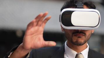 Businessman in a formal suit experiencing virtual reality with a VR headset. Modern technology meets professional innovation, exploring immersive solutions for business and communication. video