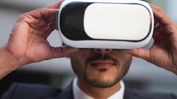 Businessman in a formal suit experiencing virtual reality with a VR headset. Modern technology meets professional innovation, exploring immersive solutions for business and communication. video