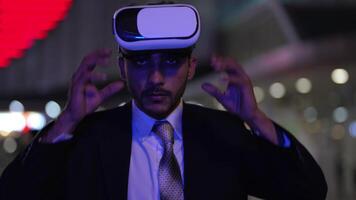 Businessman in a formal suit experiencing virtual reality with a VR headset. Modern technology meets professional innovation, exploring immersive solutions for business and communication. video