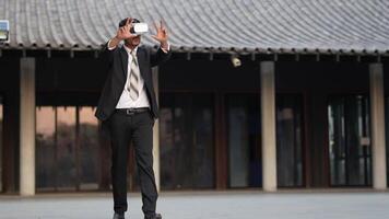 Businessman in a formal suit experiencing virtual reality with a VR headset. Modern technology meets professional innovation, exploring immersive solutions for business and communication. video