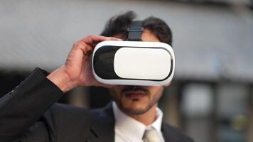 Businessman in a formal suit experiencing virtual reality with a VR headset. Modern technology meets professional innovation, exploring immersive solutions for business and communication. video