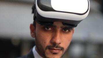 Businessman in a formal suit experiencing virtual reality with a VR headset. Modern technology meets professional innovation, exploring immersive solutions for business and communication. video