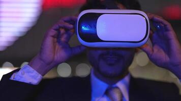 Businessman in a formal suit experiencing virtual reality with a VR headset. Modern technology meets professional innovation, exploring immersive solutions for business and communication. video