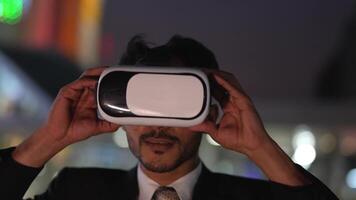 Businessman in a formal suit experiencing virtual reality with a VR headset. Modern technology meets professional innovation, exploring immersive solutions for business and communication. video