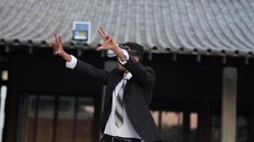 Businessman in a formal suit experiencing virtual reality with a VR headset. Modern technology meets professional innovation, exploring immersive solutions for business and communication. video