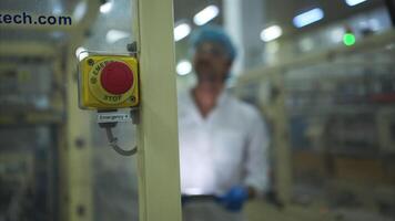 The production control supervisor inspects and controls the operation of machines in the manufacturing line of a canned fish industry video
