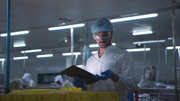 Raw material quality inspectors evaluate and inspect fish pieces before they enter the canned fish production process video