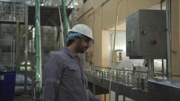Factory technicians perform routine machinery inspections while the production process is running on the production line video