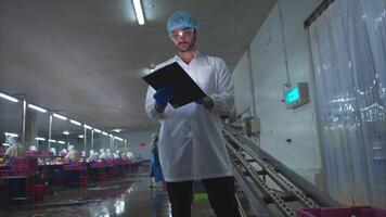 Raw material quality inspectors evaluate and inspect fish pieces before they enter the canned fish production process video