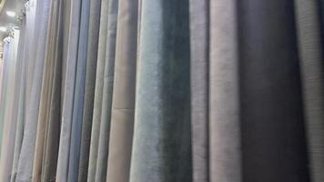 une organisé collection de en tissu draperie échantillons est affiché, mettant en valeur vibrant couleurs et riches textures en dessous de doux éclairage, offre parfait intérieur conception inspiration video