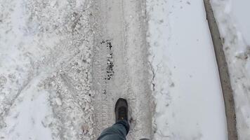 A person is walking very carefully along a snowcovered pathway, demonstrating both the challenges and the beauty that comes with winter travel during and after fresh snowfall video