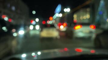A vibrant and dynamic, blurred perspective of nighttime traffic, featuring a beautiful array of colorful city lights and the lively movement of vehicles along a bustling urban street video