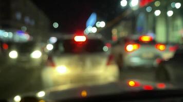 A vibrant and dynamic nighttime scene depicting the urban traffic flow, complete with glowing lights and blurred vehicles, effectively capturing the energetic hustle and bustle of city life video