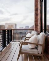A side view of a contemporary, coy apartment balcony relaxation area featuring a city view. photo