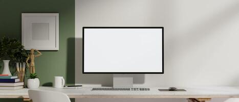 A front view of a computer with a white screen mockup on a table against the wall in a modern room. photo
