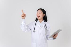 A doctor holding a digital tablet, pointing, and looking to the side as if thinking of an idea. photo