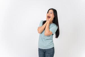 An excited Asian woman on a studio background with a surprising face expression. wow, amazed photo