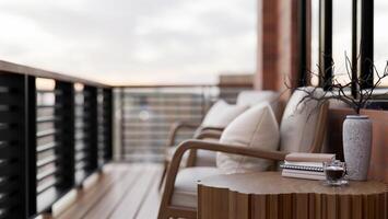 A wooden side table on a contemporary apartment balcony relaxation space with a city view. photo