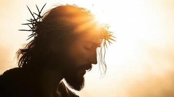 Silhouette of Jesus with a crown of thorns on his head, facing away from the camera photo