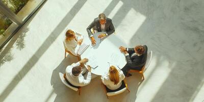 People sitting at a table with papers in front of them photo