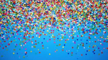 Colorful confetti falls against a blue background, creating a festive atmosphere with shimmering particles photo