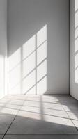 Bright sunlight filtering across white walled interior, casting long shadows on minimalist tiled flooring background photo