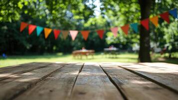 Empty wooden table top with a blurred background of colorful flags and a green tree photo