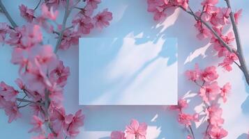 spring pink flowers surrounding blank card mock up against pristine backdrop, offering minimalist wedding stationery or design element with elegant simplicity photo
