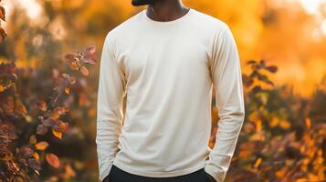 Long Sleeve T-shirt in a park during fall on a man standing in nature with hands in pockets, perfect autumn mockup for your design photo