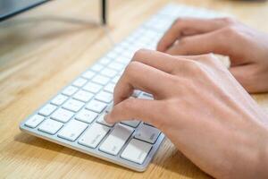 The man is typing the keyboard photo