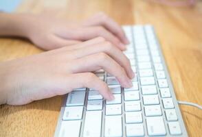 The girl is typing the keyboard photo