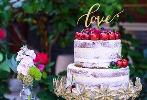 Multilayered wedding cake covered in white icing sugar photo
