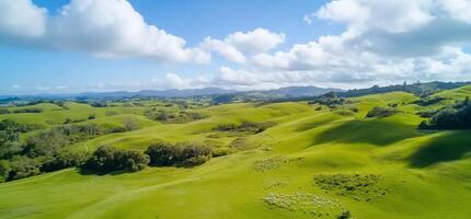 Lush green hills under a bright blue sky with scattered clouds. photo